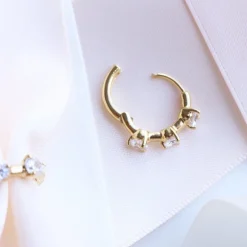 SCATTERED LOVE HUGGIE HOOPS - CUBIC ZIRCONIA & GOLD